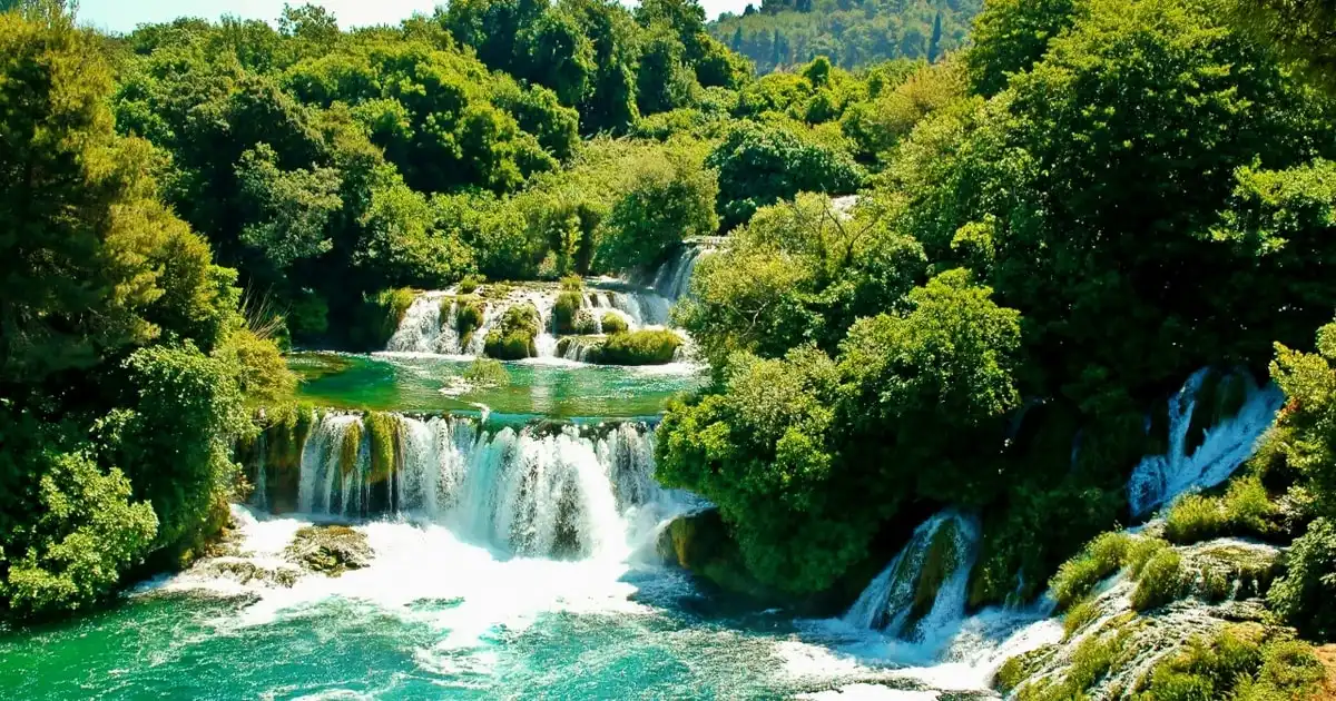Green water spilling over the travertine barriers at Skradinski Buk on the Krka waterfalls day tour with guide from Zadar